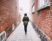 Woman walking in the street photographed from behind